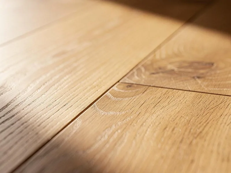 Light oak hardwood floor, the kind of hard sealed finish a chair leg slides on